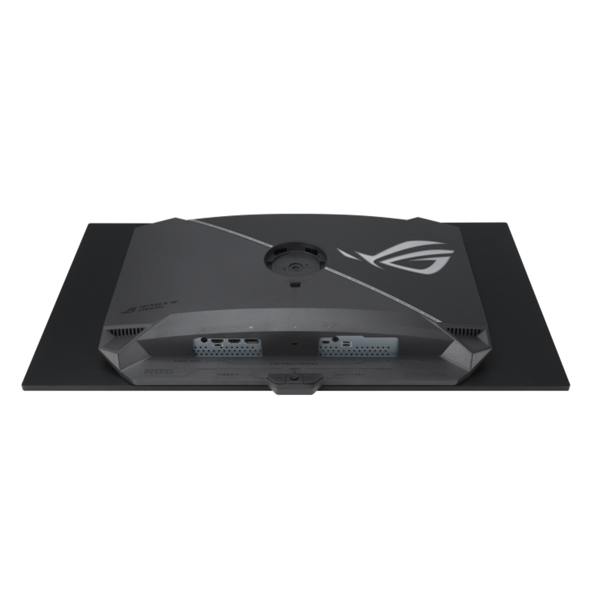 L'arrière d'un écran d'ordinateur noir. Il comporte des ports, un support et le logo ROG. L'écran est posé sur une surface noire.
