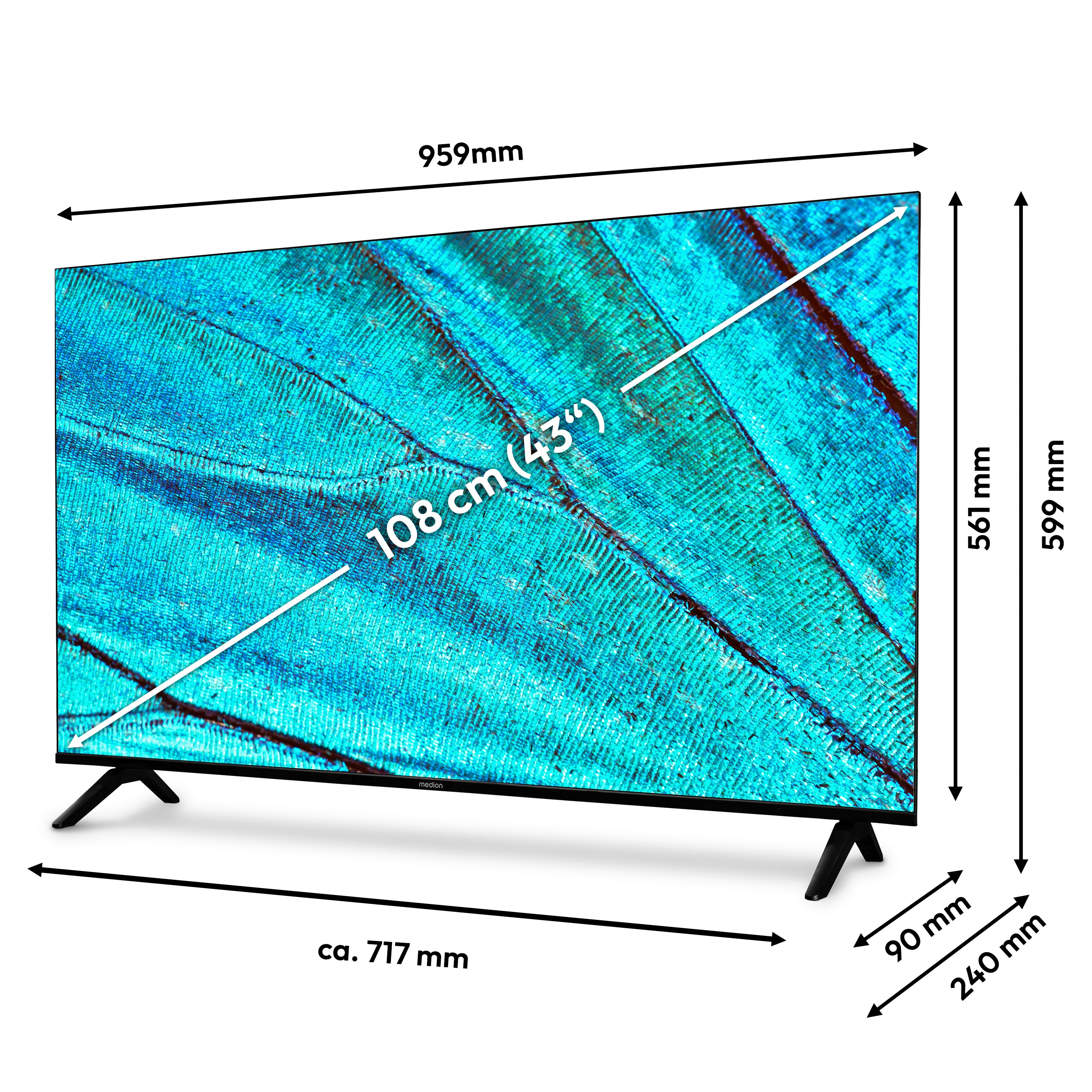 Een tv-scherm toont een blauw patroon. Afmetingen: 959 mm breed, 599 mm hoog. Het staat op zwarte poten.
