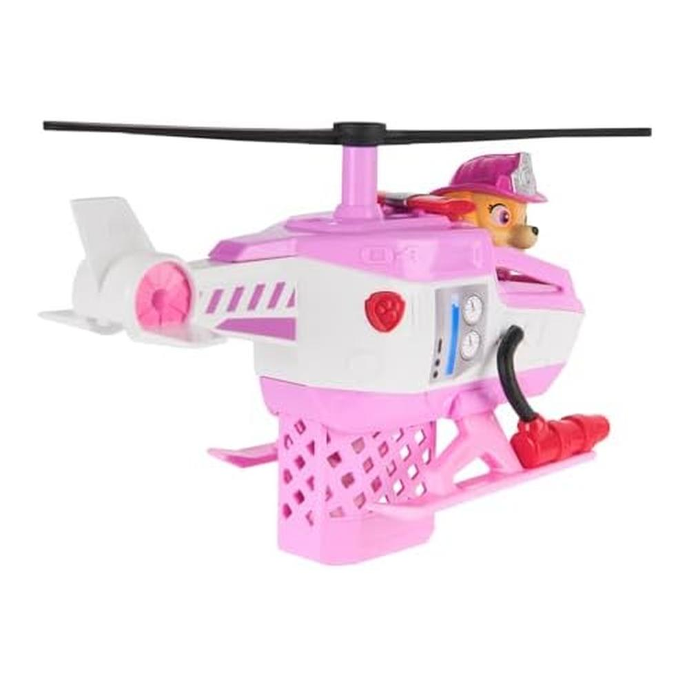 Ein rosa-weißer Spielzeughelikopter mit einer Paw Patrol-Figur. Die Rotorblätter sind schwarz. Der Hubschrauber hat ein rosa Fahrwerk.
