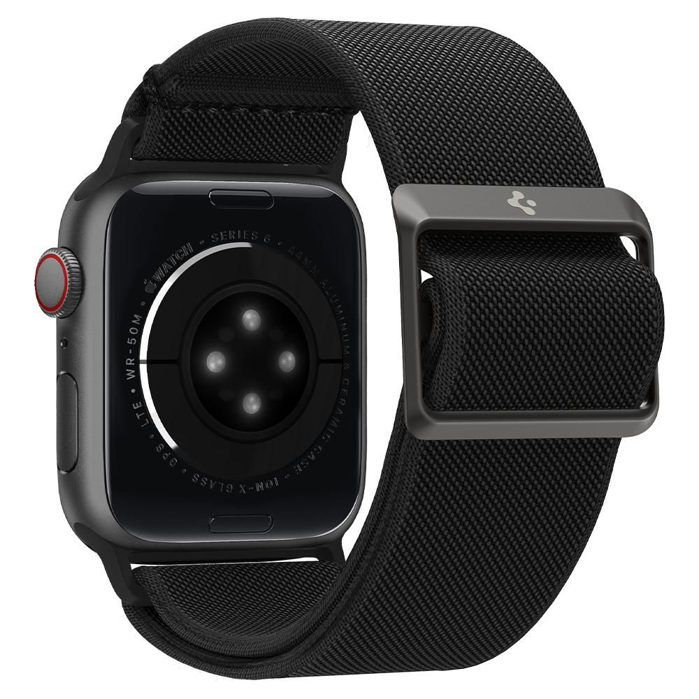 A close-up of a black Apple Watch Series 6 with a black woven band. The watch shows the back with sensors and text.