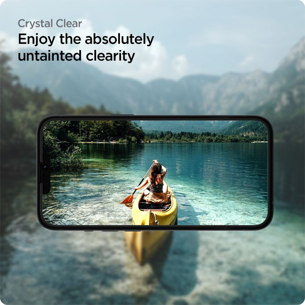 Osoba w żółtej kanu wiosłuje po jeziorze, otoczona górami i drzewami. Scena jest widoczna przez ekran telefonu.