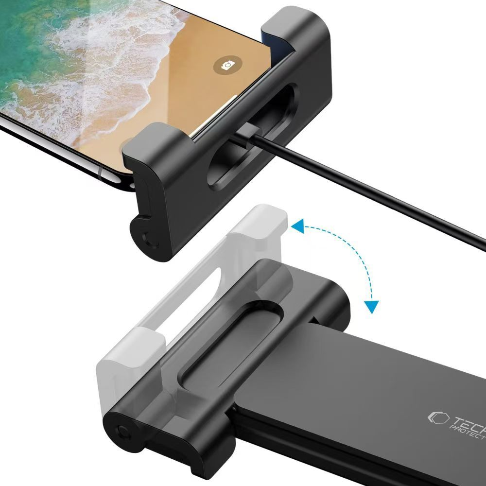 Ein schwarzer Telefonhalter mit einem Telefon darin, ein Kabel ist angeschlossen. Ein weißer Halter wird als Geist dargestellt.