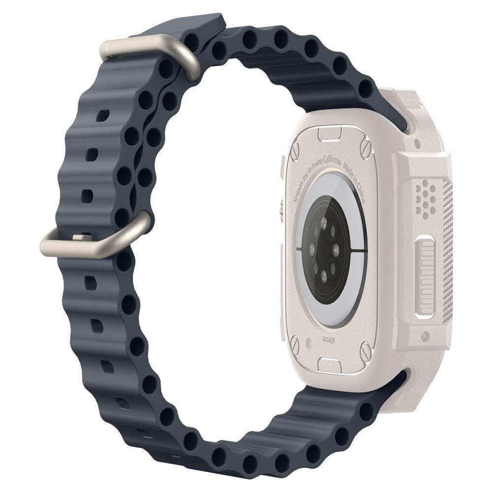 Apple Watch z ciemnoszarym paskiem i białą obudową. Pasek ma falisty wzór i jest zabezpieczony metalową klamrą.