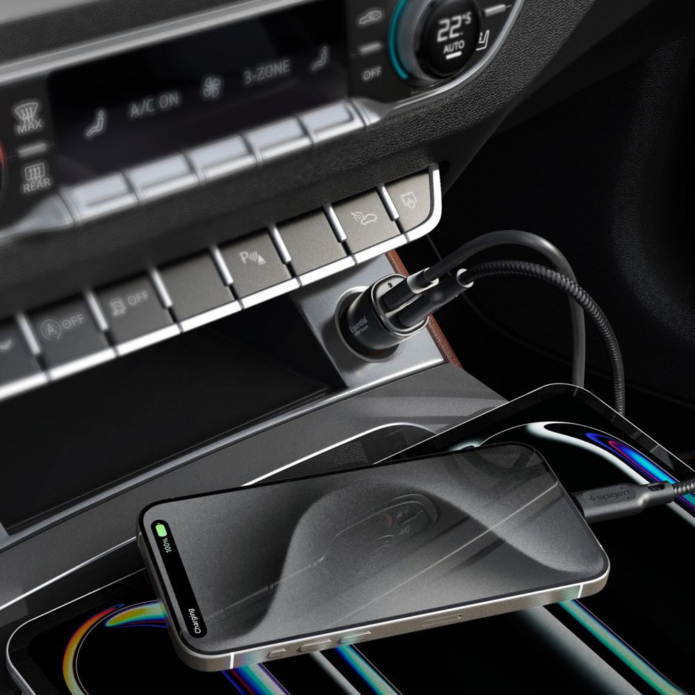A phone charging in a car. The phone is on a car console, with a charging cable connected to a car charger.
