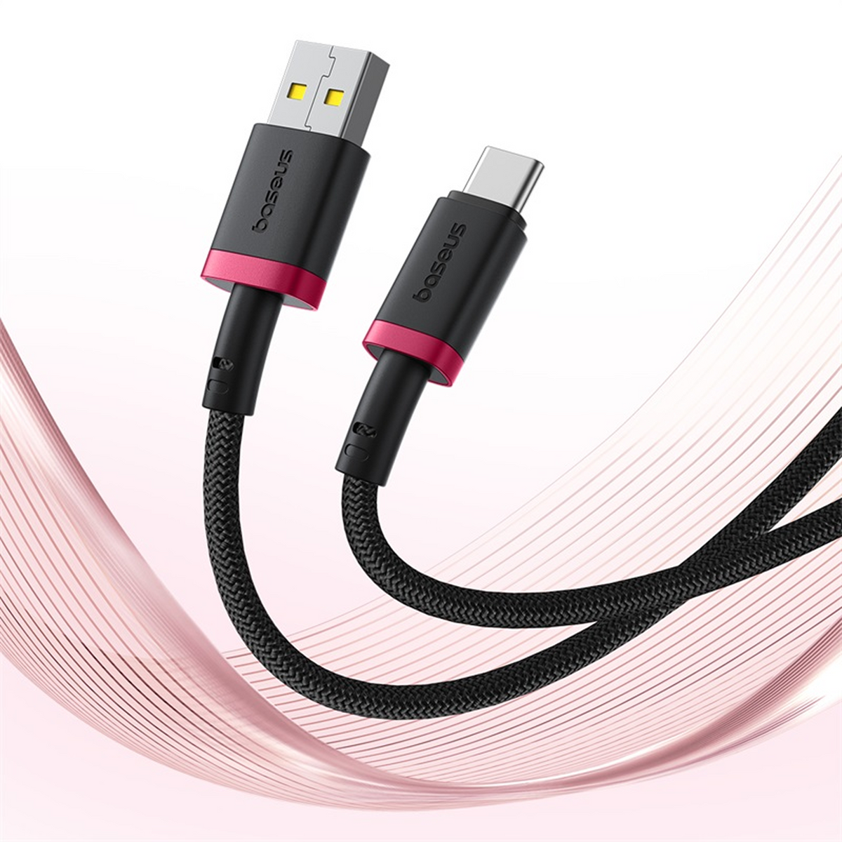 Cable de carga USB-C negro y rosa con conector USB-A y cable trenzado, el fondo tiene líneas de ondas rosas.
