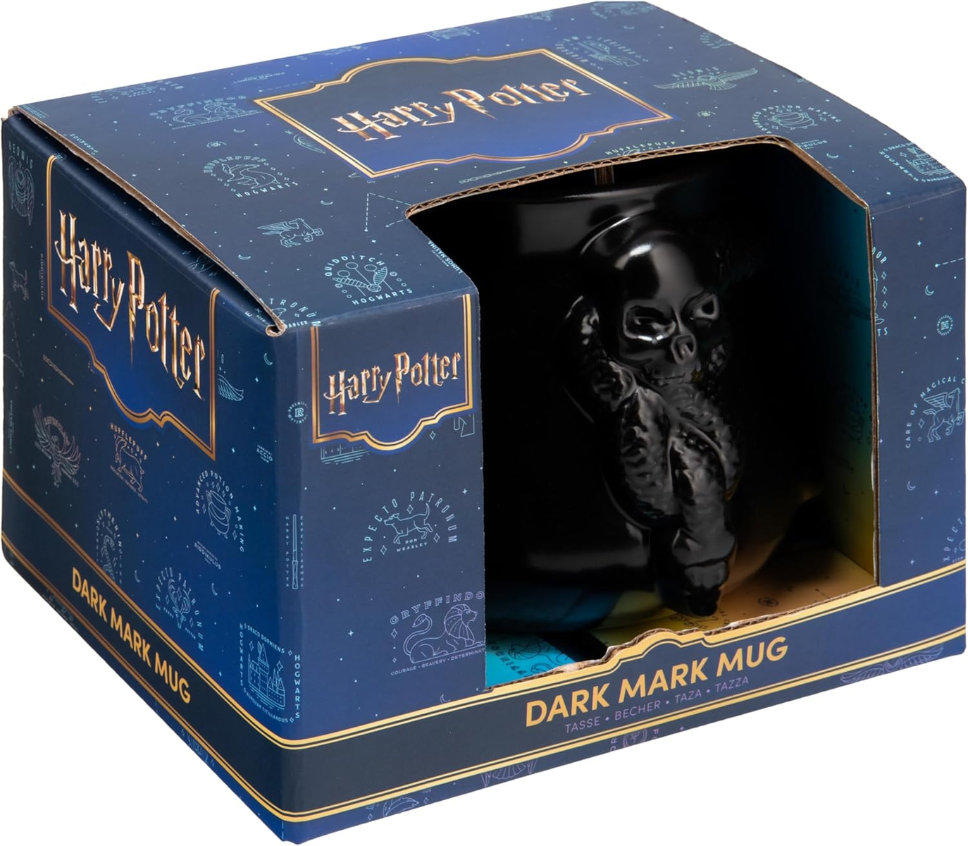 Una taza de la Marca Tenebrosa en una caja de Harry Potter. La caja es azul oscuro con detalles dorados y las palabras 'Harry Potter'.
