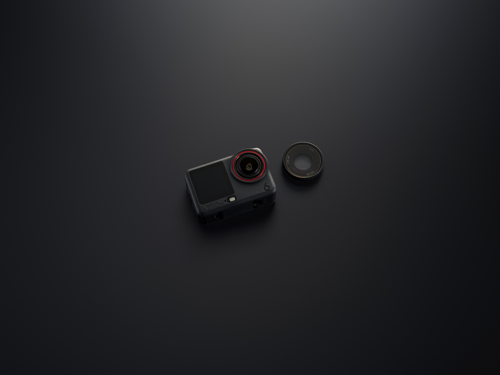 Una cámara de acción negra con un anillo rojo alrededor de la lente se encuentra junto a una lente sobre una superficie gris oscura.