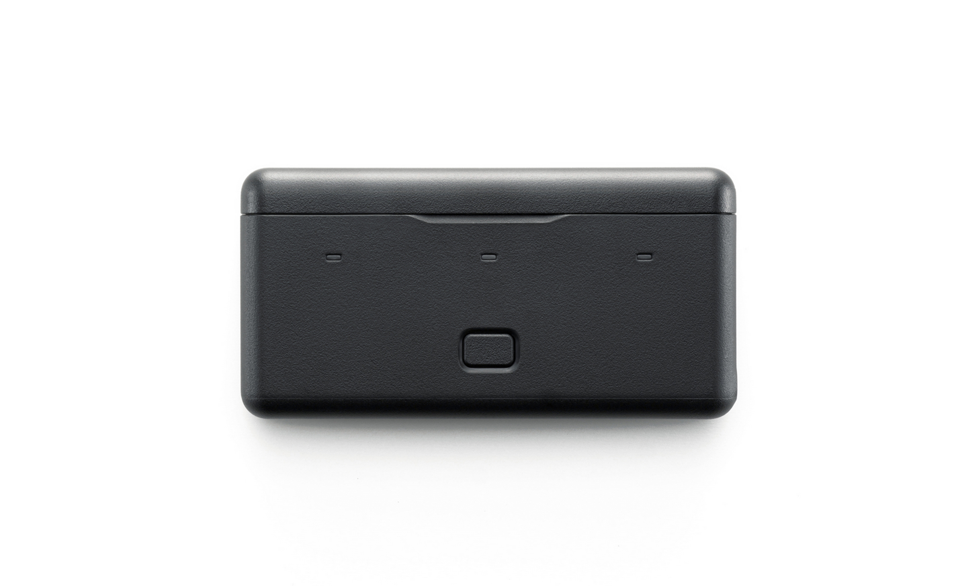 Un appareil rectangulaire noir avec un bouton, posé sur fond blanc. Il possède plusieurs petites ouvertures.