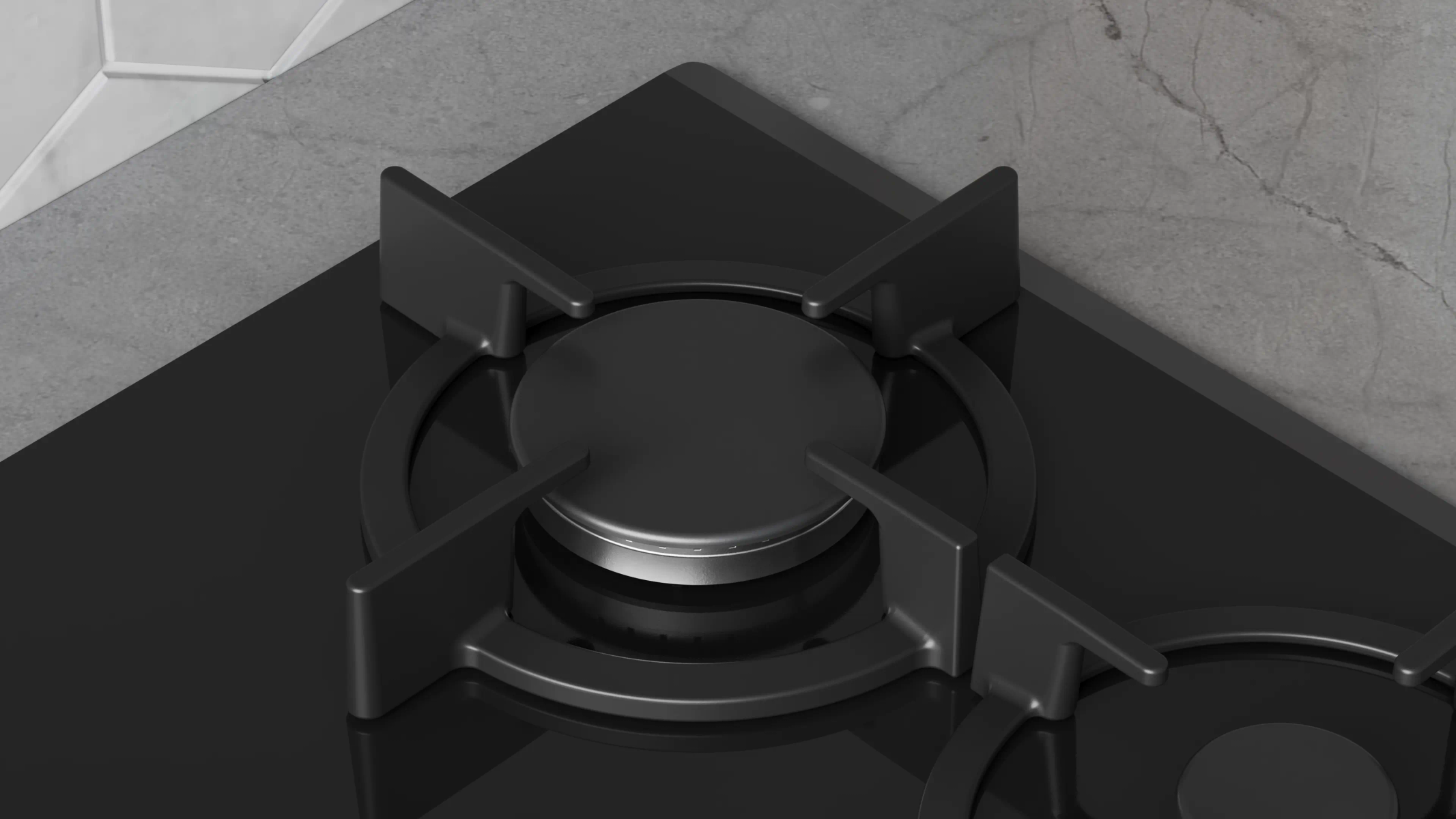 Primer plano de una cocina de gas negra con superficie brillante. El quemador está enfocado, sobre una encimera gris.