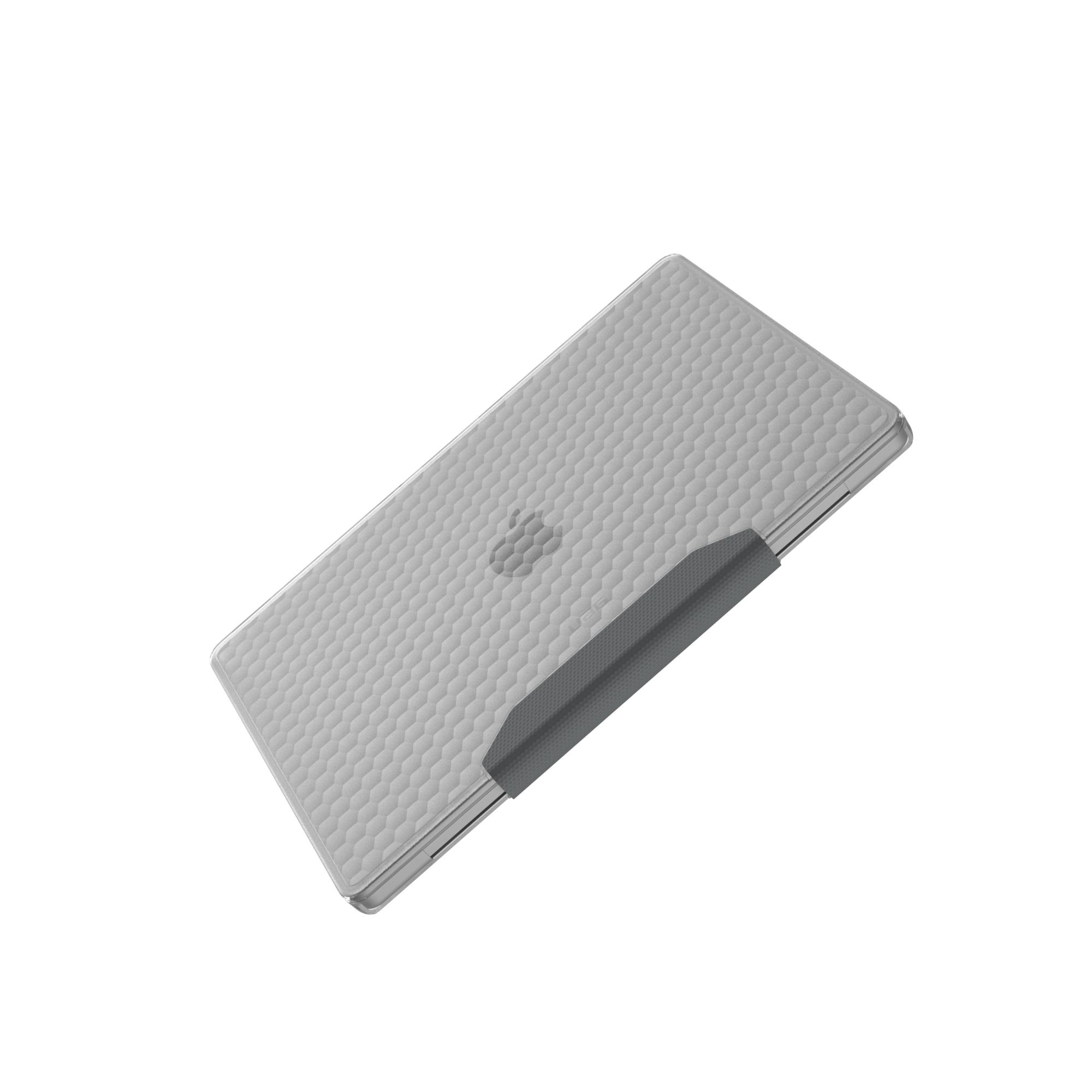 Szary laptop z sześciokątnym wzorem na białym tle. Ciemnoszary pasek znajduje się w pobliżu zawiasu.