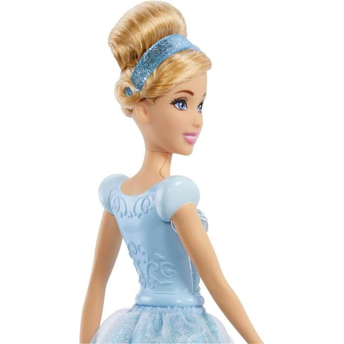 Una muñeca de Cenicienta con moño rubio y vestido azul, diadema. La muñeca mira hacia un lado.