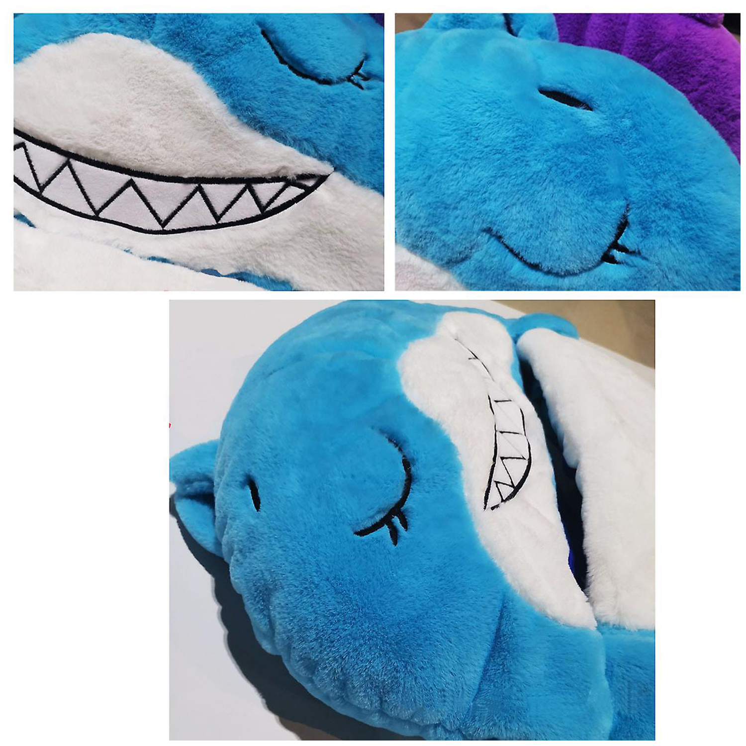 Primo piano di una testa di squalo di peluche con pelliccia blu e bianca. Ha una bocca sorridente con denti neri e occhi chiusi.