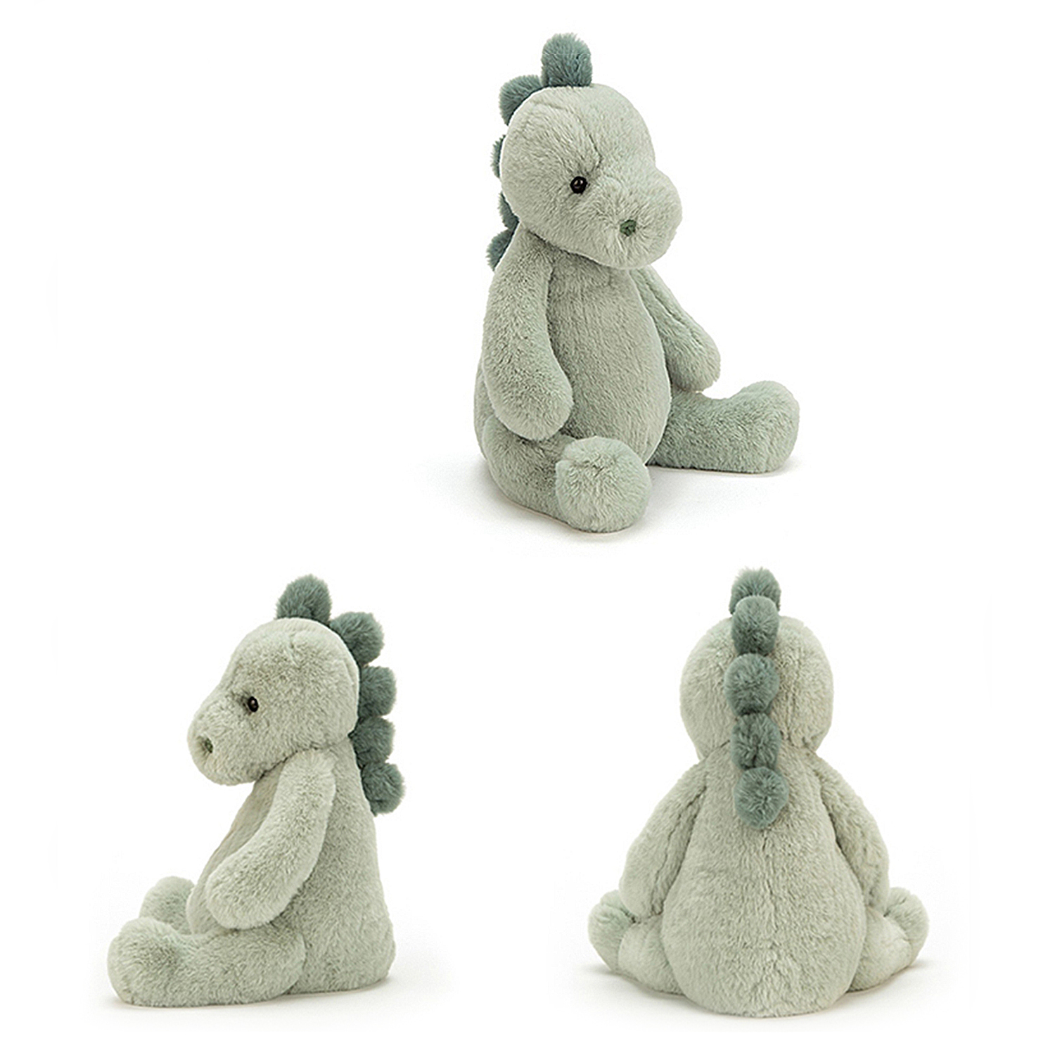 Un giocattolo a forma di dinosauro di peluche morbido, verde chiaro, con spine verdi più scure, seduto su uno sfondo bianco. Ha un aspetto carino e coccoloso.