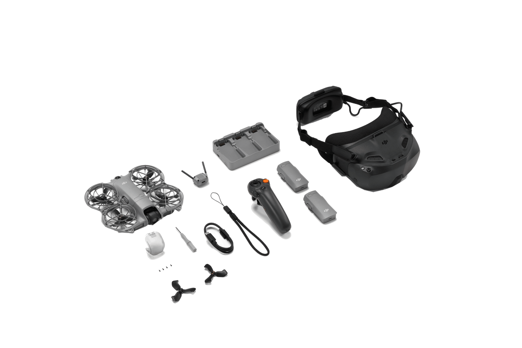 Zestaw drona z dronem, goglami, pilotem, bateriami, ładowarką i akcesoriami, wszystko na czarnym tle.