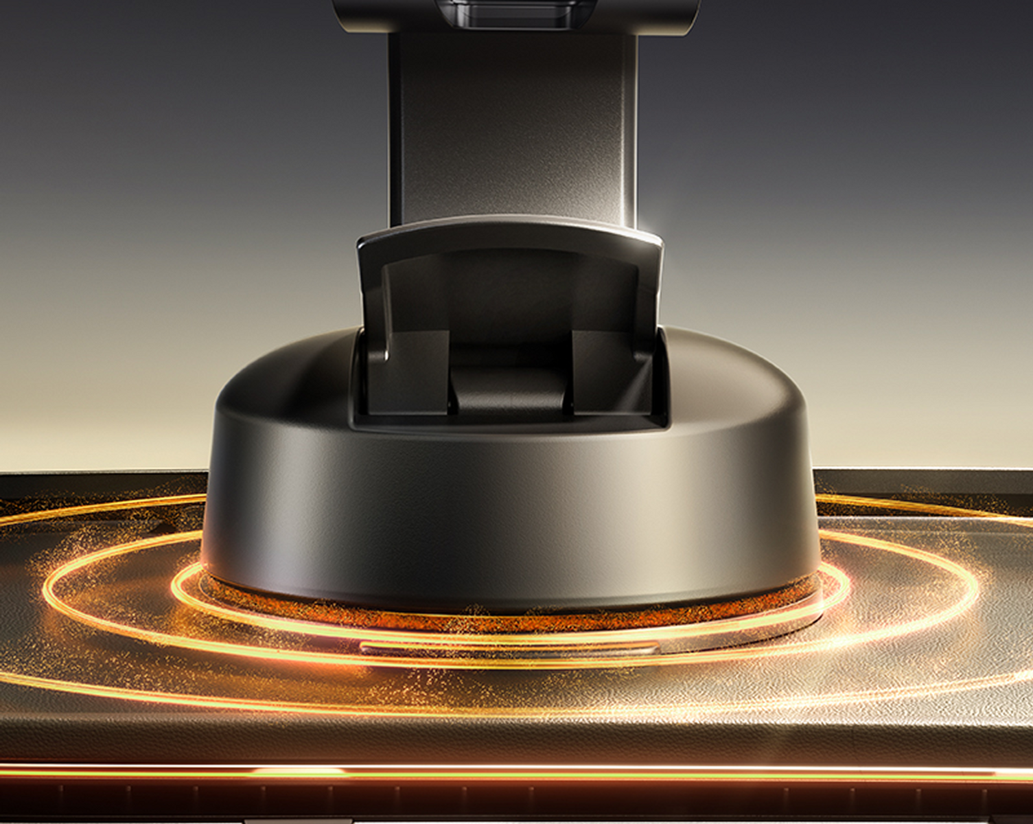 Primo piano di un dispositivo nero con base circolare. Linee dorate brillanti circondano la base. Lo sfondo sfuma da scuro a chiaro.