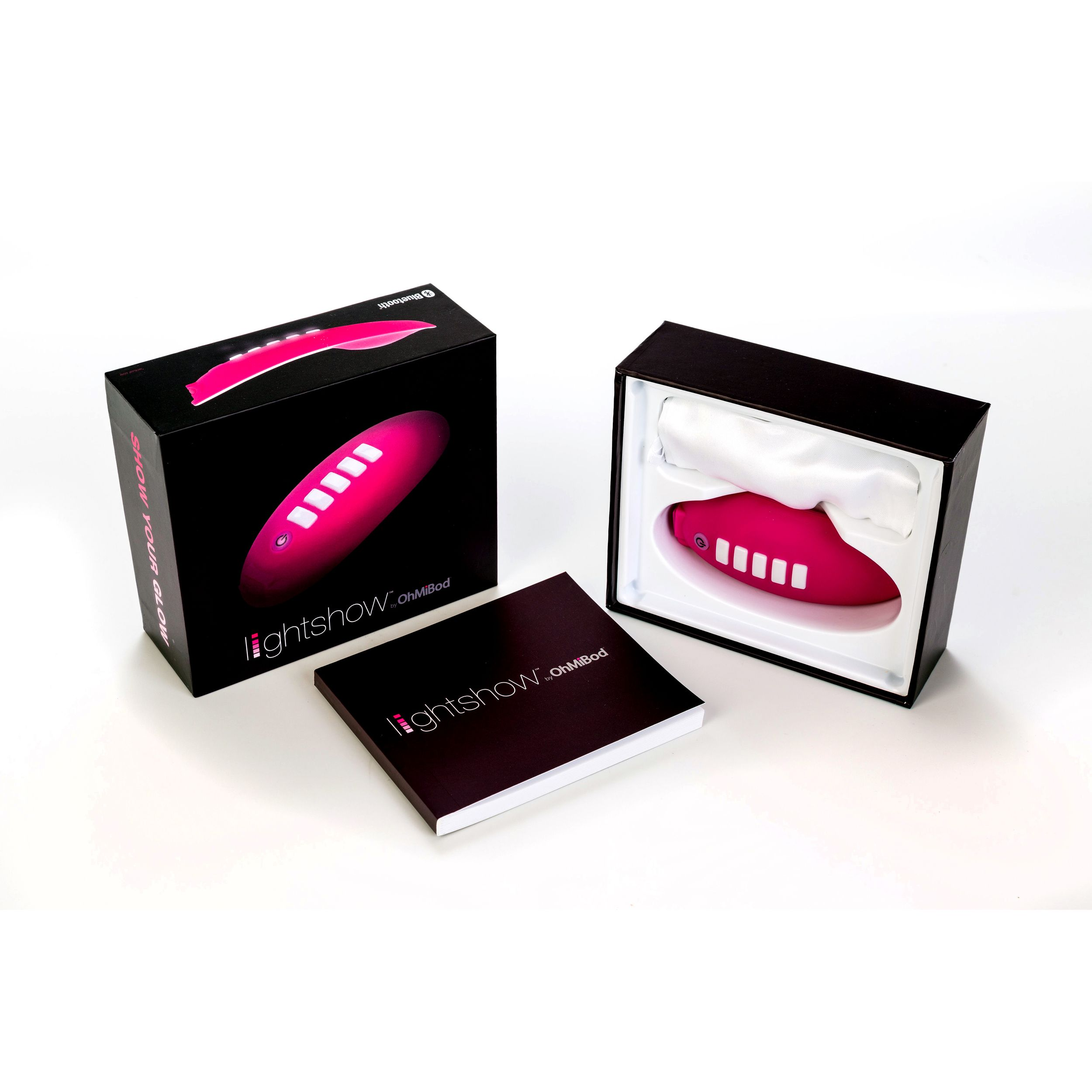 Rosa Lightshow OhMiBod-Produkt mit Verpackung und Broschüre auf weißem Hintergrund. Boxen und Produkt sind sichtbar.