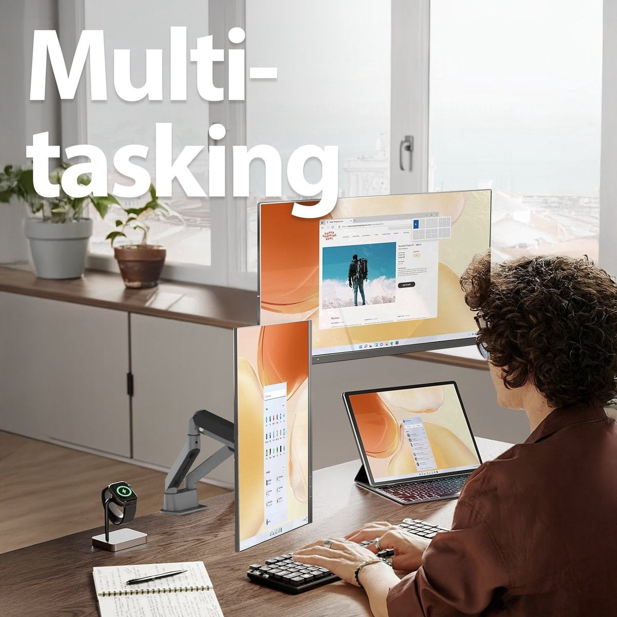 A person is multitasking on a desk with multiple monitors, a laptop, and a smartwatch. The scene conveys productivity.