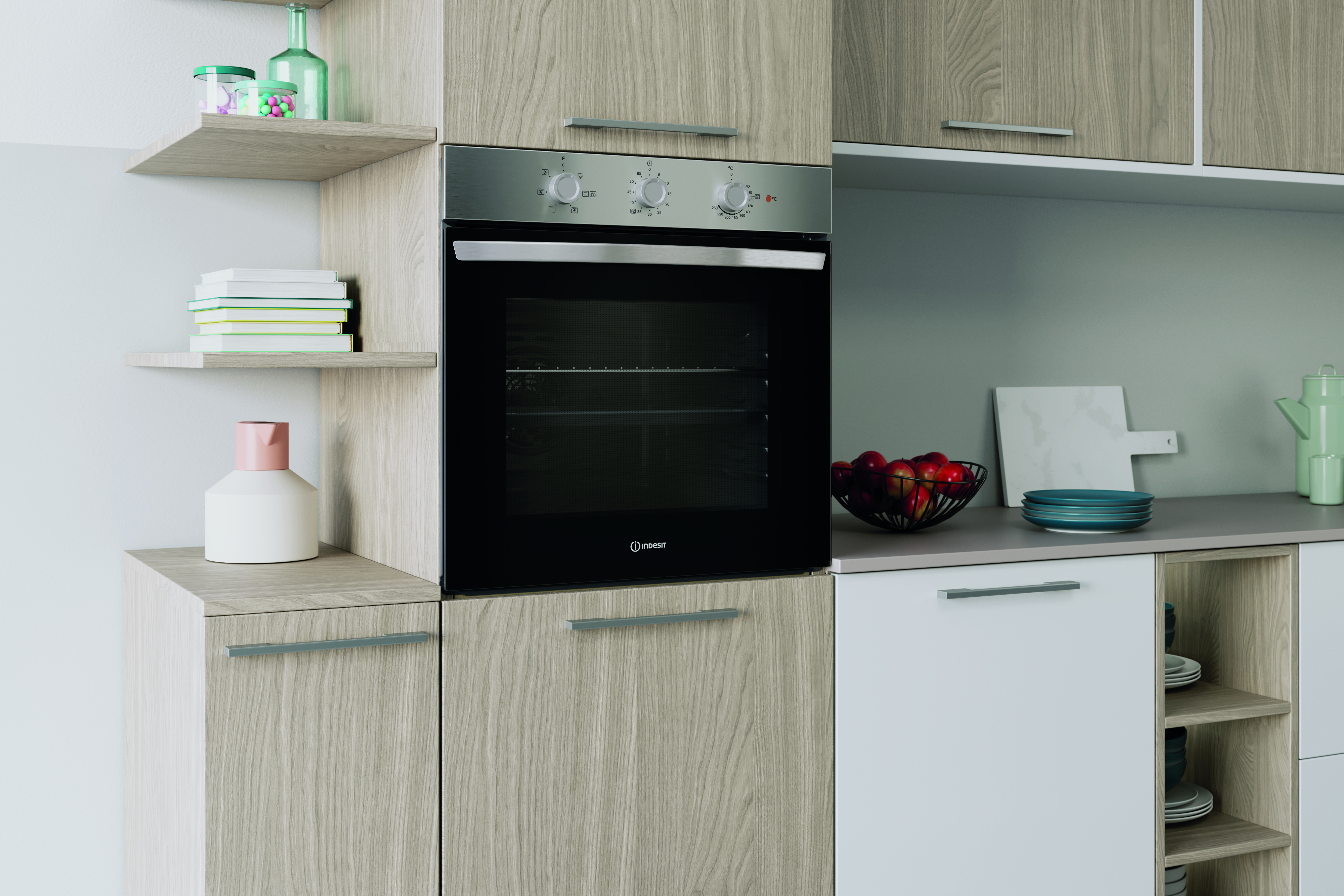 Una scena di cucina con forno, armadi e mensole con barattoli, bottiglie, libri e frutta.