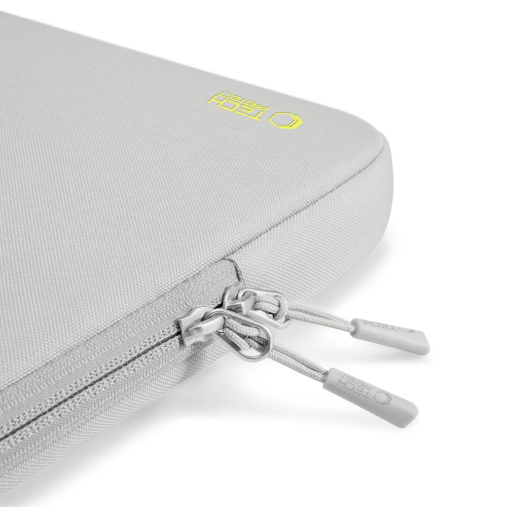 Een close-up van een lichtgrijze laptoptas met een rits. De ritstrekkers zijn zilver en de merknaam is geel zichtbaar.