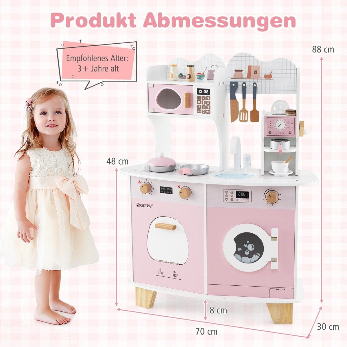 Una niña está junto a una cocina de juguete rosa con electrodomésticos. Tiene microondas, estufa, fregadero y lavadora. Se proporcionan dimensiones.