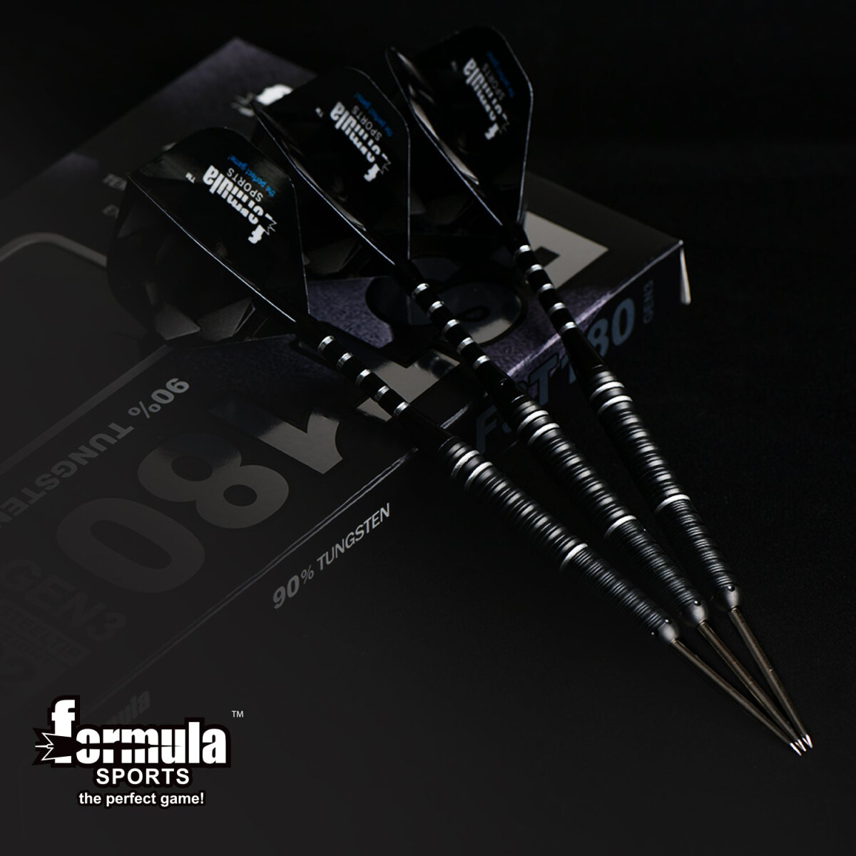 Four black darts with silver stripes on a box with text 'Formula Sports'. Dark background.