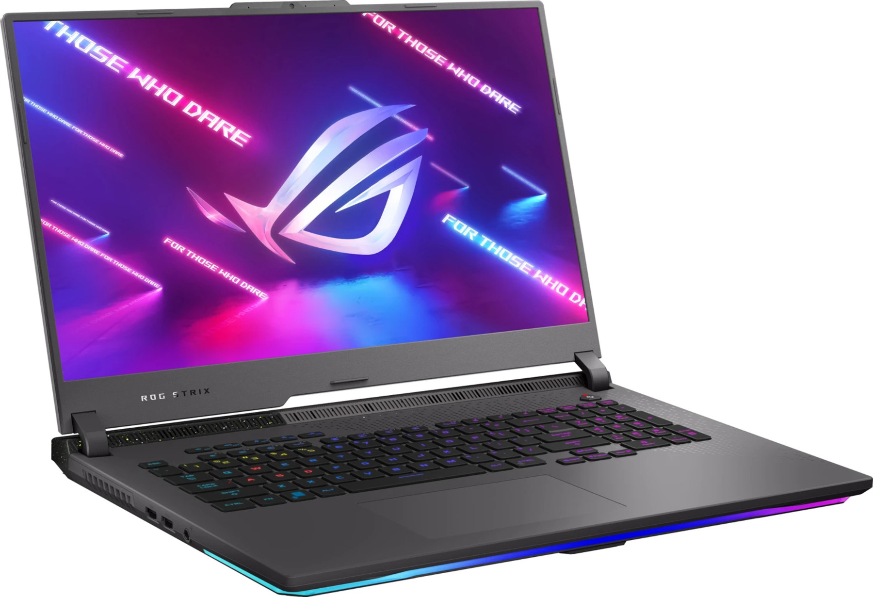 Szary laptop ROG Strix jest otwarty. Ekran wyświetla logo i tekst 'For those who dare'. Klawiatura jest widoczna.
