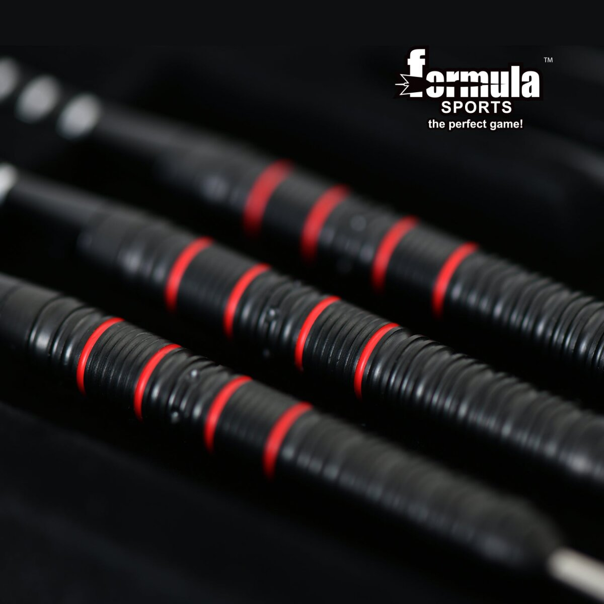Close-up of three black dart barrels with red rings. The brand name 'Formula Sports' is visible in the upper right corner.