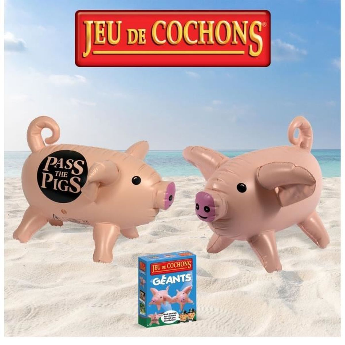 Due maiali gonfiabili su una spiaggia con una scatola di gioco. I maiali sono rosa chiaro con occhi neri e nasi rosa.