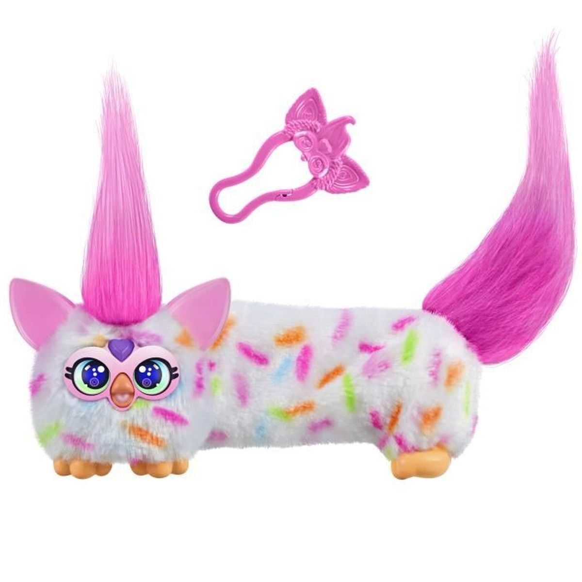 Ein weißes Furby-Spielzeug mit bunten Streuseln, rosa Ohren, einem rosa Haarbüschel und einem rosa Schwanz. Ein rosa Zubehör ist ebenfalls vorhanden.