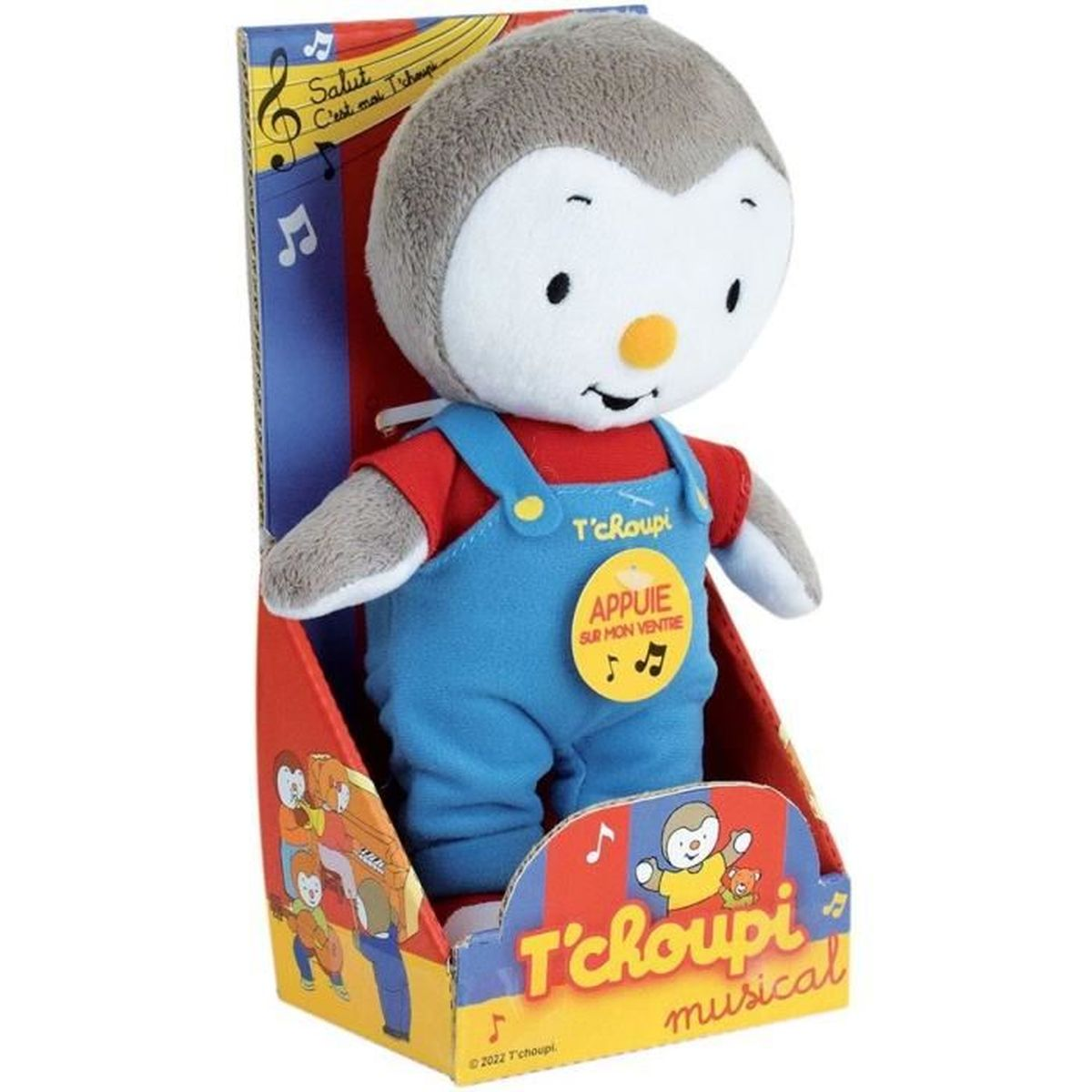 Ein T'choupi-Plüschtier in einer Box. Es trägt blaue Latzhosen und ein rotes Hemd. Auf der Box steht 'T'choupi musical' und 'Appuie sur mon ventre'.