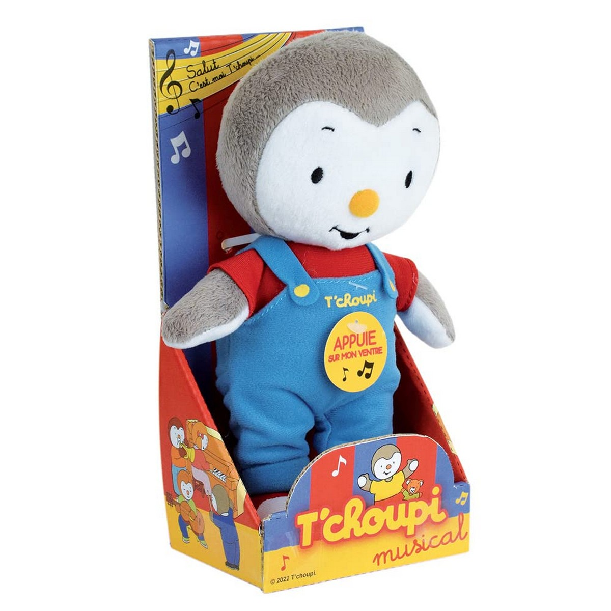 Ein T'choupi-Plüschtier in seiner Box. Es trägt blaue Latzhosen und ein rotes Hemd. Die Box hat Noten und die Worte T'choupi.
