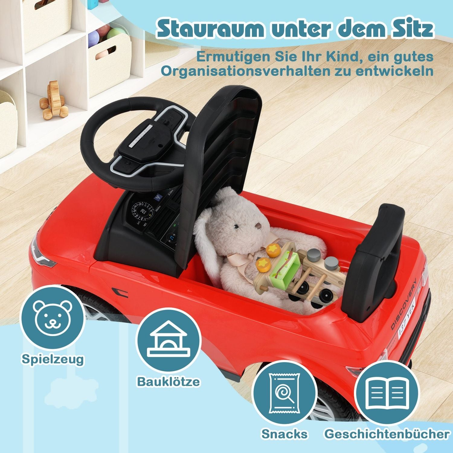 Un coche de juguete rojo con volante y un conejito de peluche dentro. El coche tiene etiquetas para juguetes, bloques, snacks y libros.