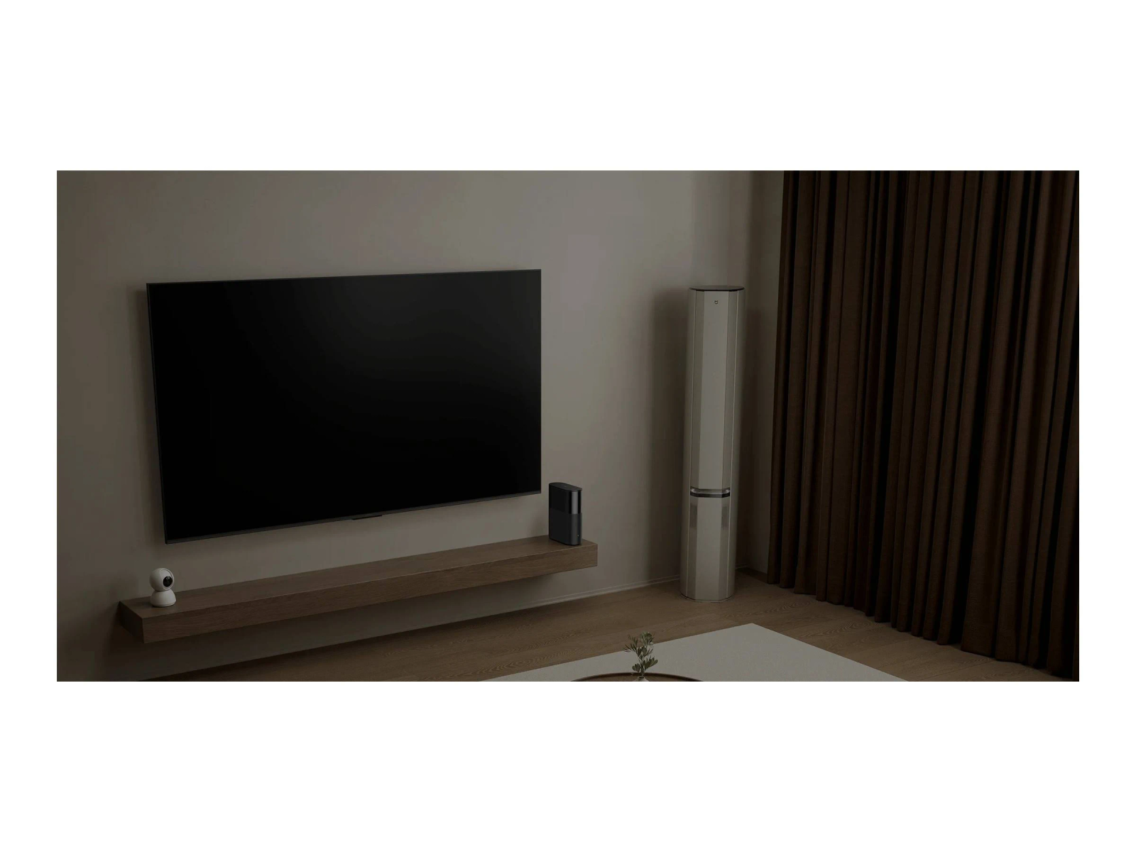 A modern living room with a large TV, speaker, brown curtains, and a white coffee table.