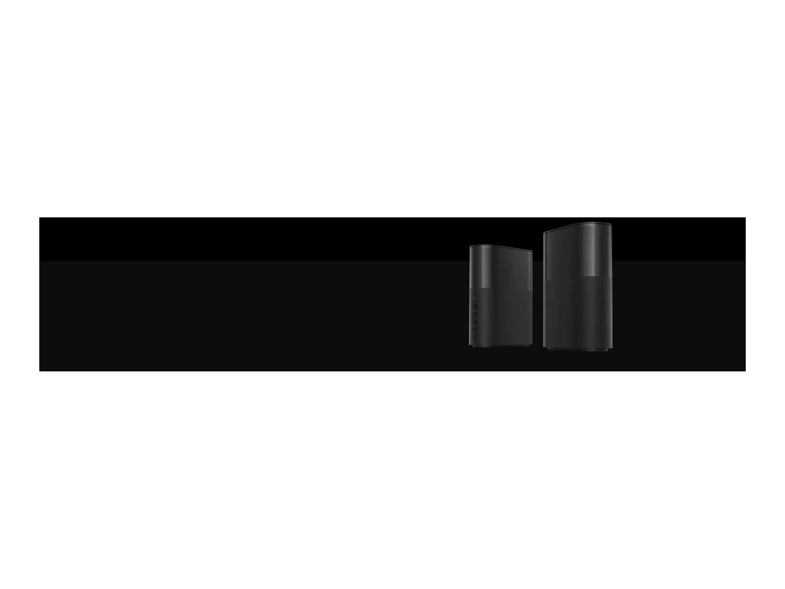 Two black computer towers on a black surface. The background is white.