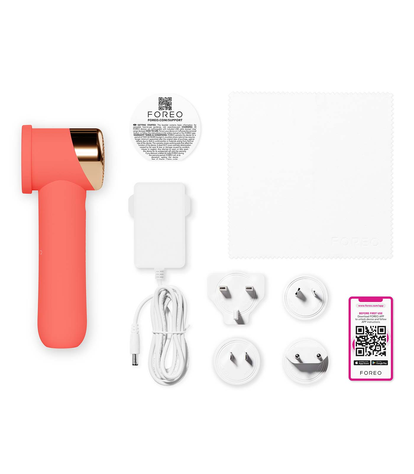 A coral beauty device with gold accents, charger, plugs, cloth, and instructions. A QR code for app download is also visible.