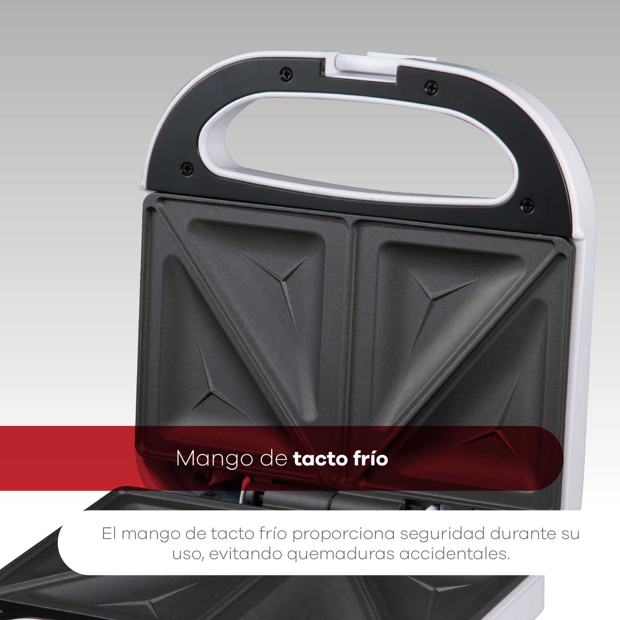 Sandwichera abierta con interior negro, exterior blanco y asa. Texto: Mango de tacto frío para un uso seguro y sin quemaduras.