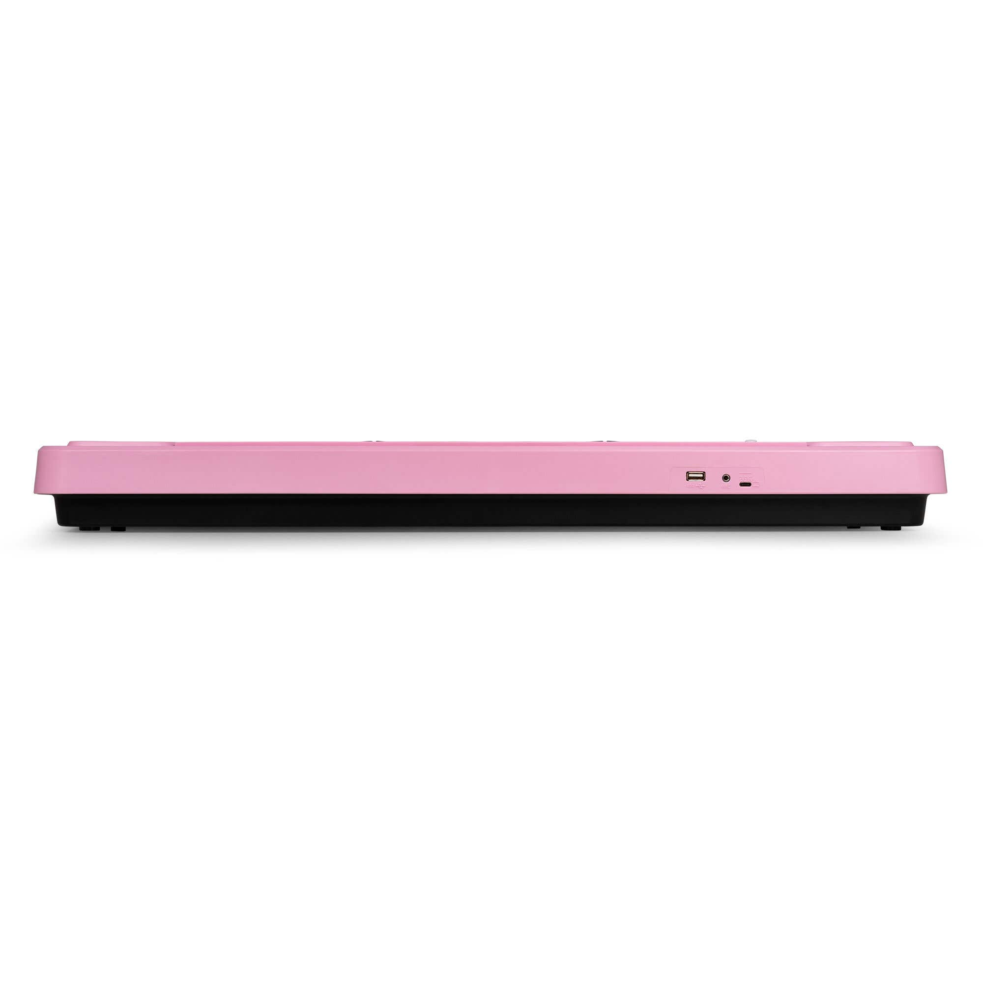 Un teclado rosa con base negra se ve desde un lateral. Tiene varios puertos en el lateral.