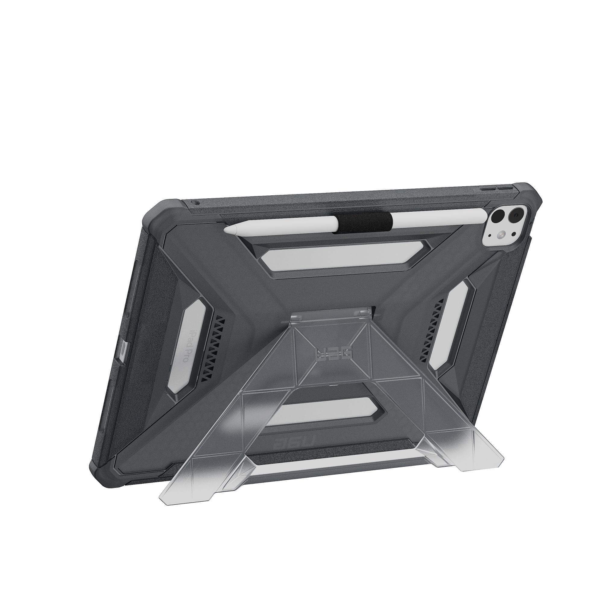 Ciemnoszary iPad Pro w etui ze stojakiem. Dołączony jest biały długopis. Tło jest białe.