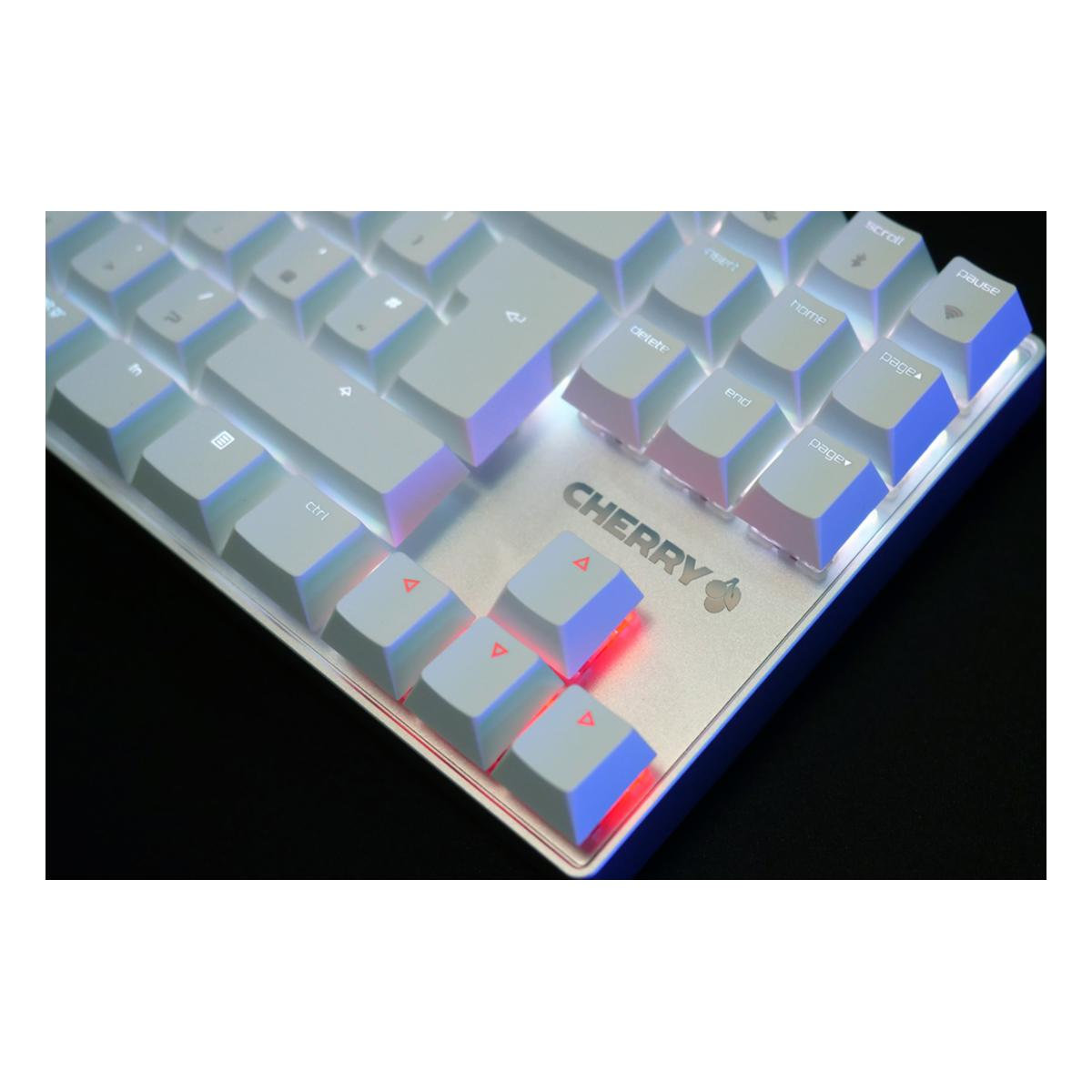 Biała klawiatura Cherry z podświetlanymi klawiszami. Klawiatura ma srebrną ramkę i czarne tło.