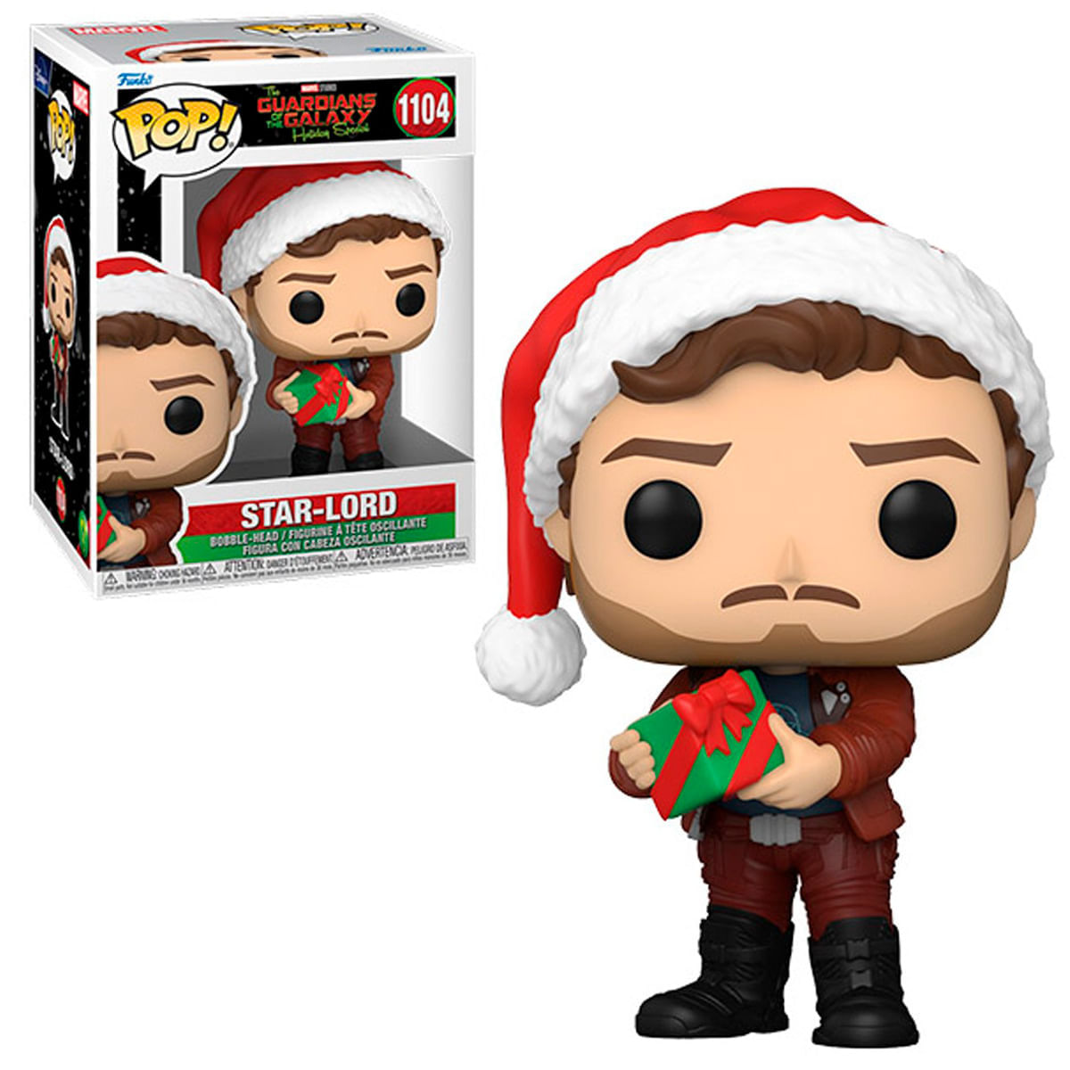 Una statuetta Funko Pop di Star-Lord con cappello da Babbo Natale e un regalo. La scatola è sullo sfondo.