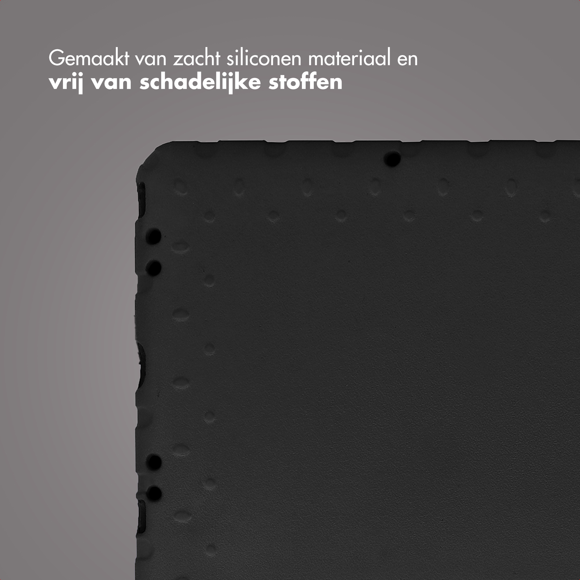 Close-up of a black textured surface with small dots and a few holes. Text at top: Made of soft silicone.