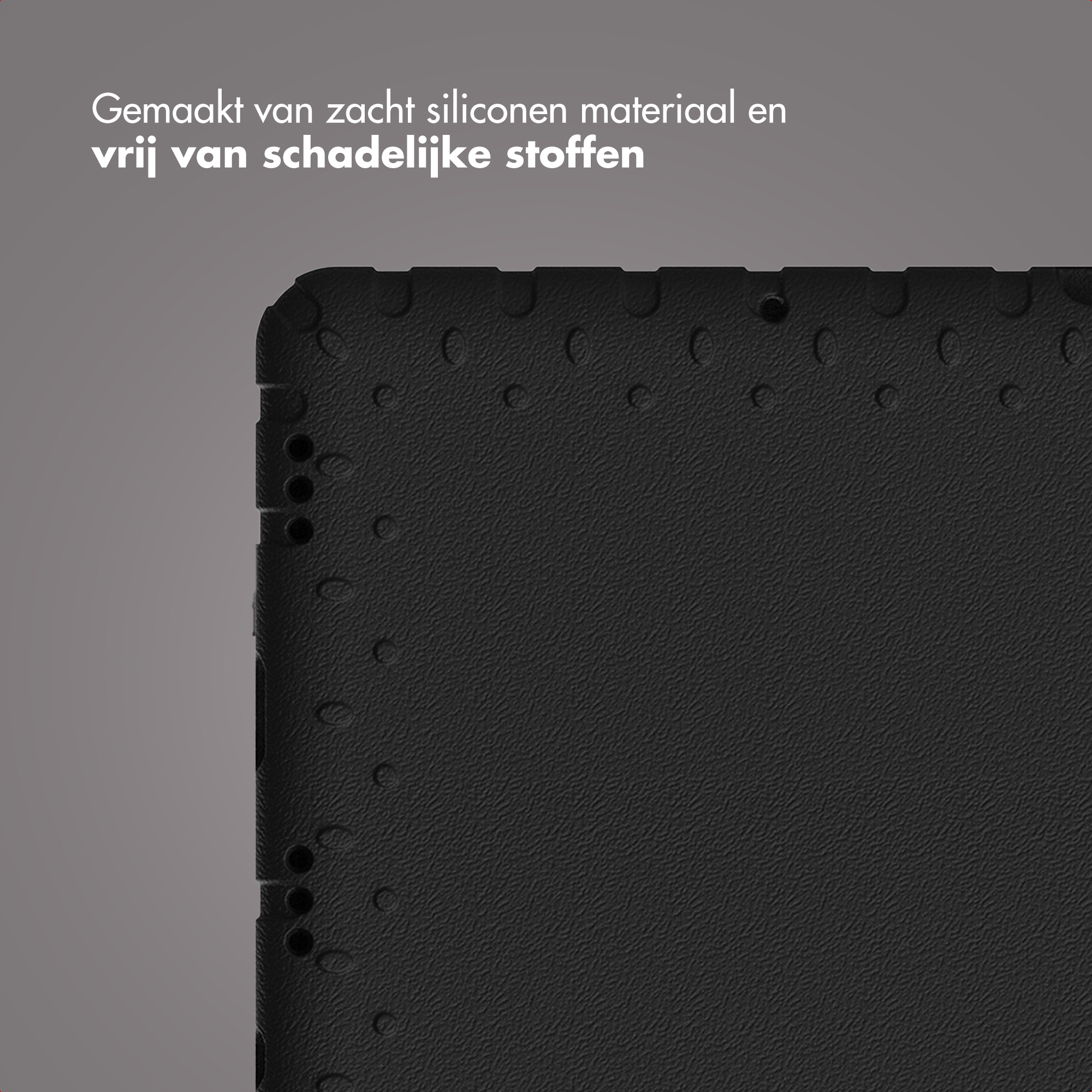 Close-up van een zwarte, getextureerde oppervlakte met kleine cirkelvormige inkepingen. Tekst: Gemaakt van zacht siliconen materiaal, vrij van schadelijke stoffen.
