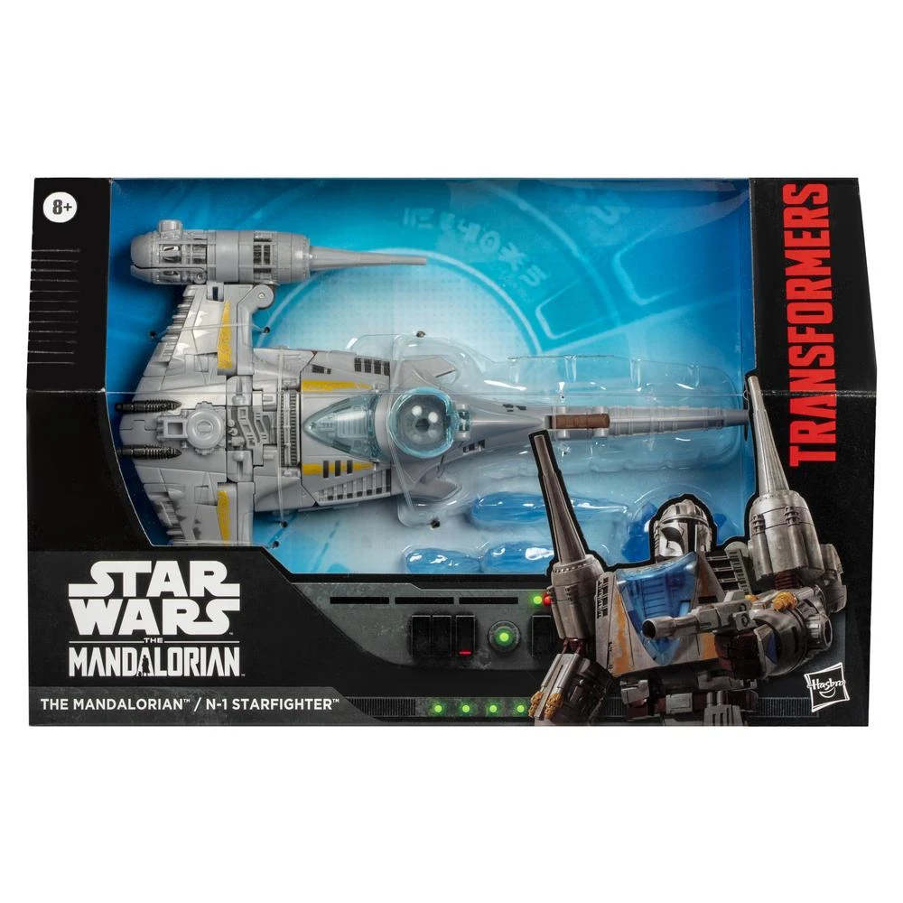 Bir Star Wars Mandalorian N-1 Starfighter oyuncağı bir kutuda. Kutuda Transformers logosu var. Oyuncak gri, mavi ve şeffaf bir kokpite sahip.