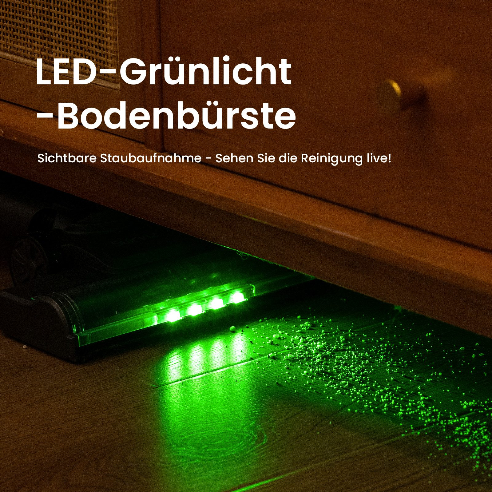 Aspirapolvere con luci LED verdi sotto i mobili, che illuminano le particelle di polvere sul pavimento in legno.