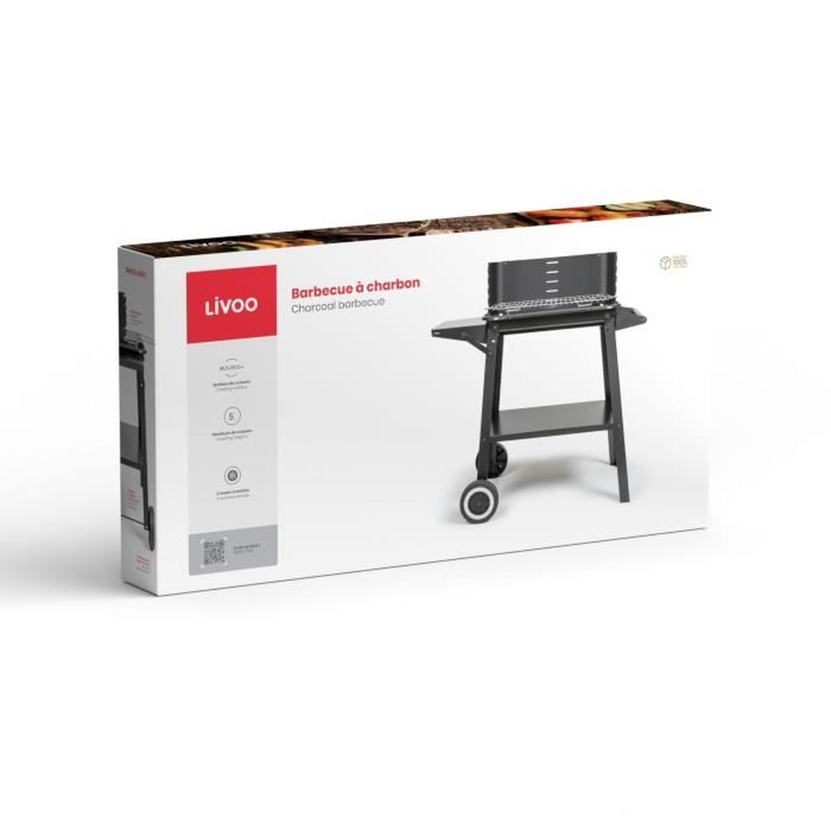 Een houtskoolbarbecue op een witte achtergrond, in een doos. De doos heeft het merk 'Livoo'.