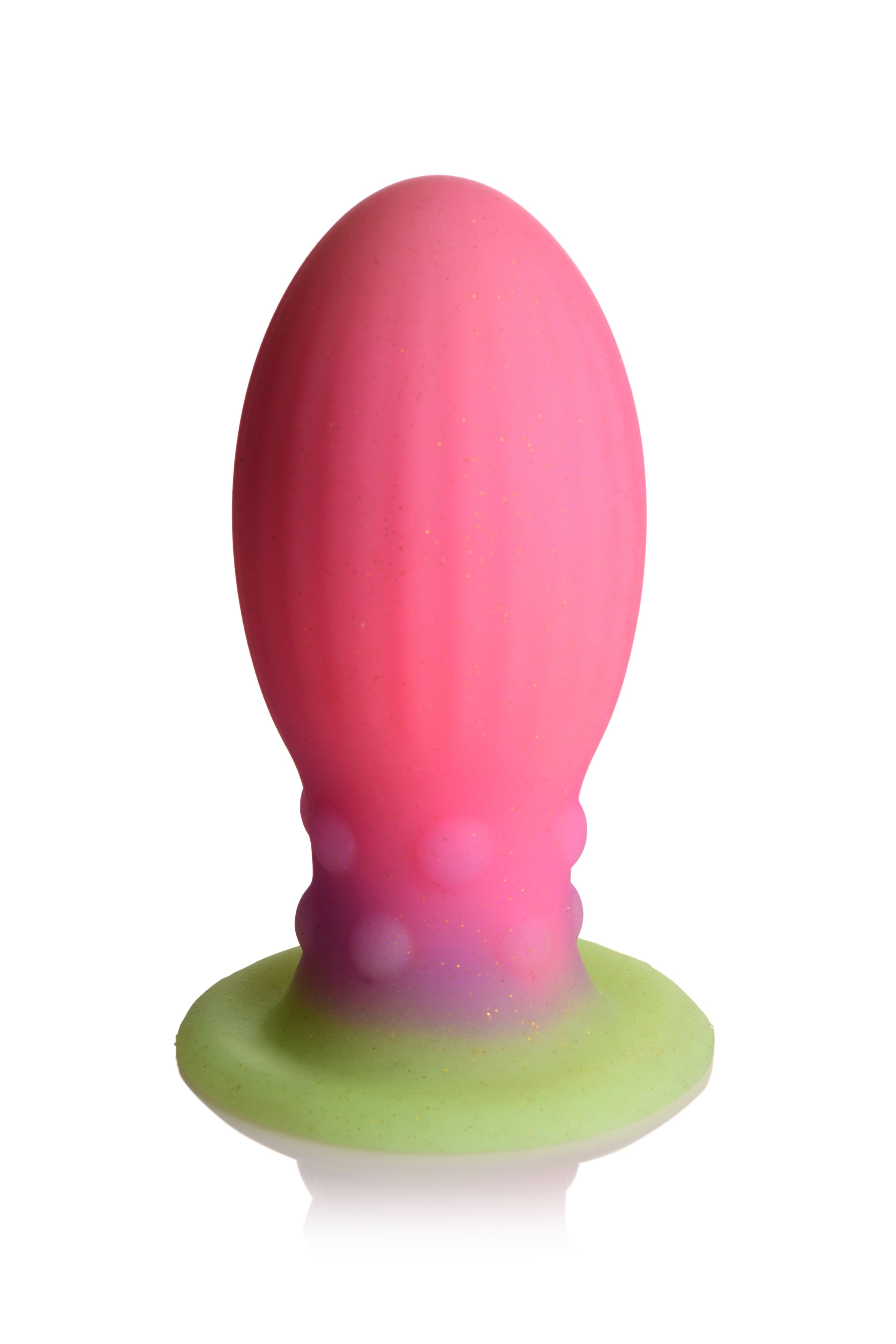 Ein rosafarbenes und violettes Sexspielzeug mit grünem Sockel, vor weißem Hintergrund.