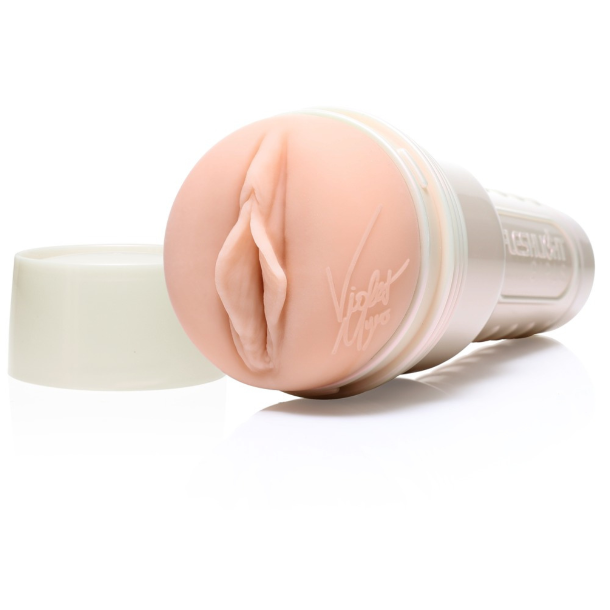 Ein Fleshlight mit realistischer vaginaler Öffnung, hellrosa. Die Basis ist weiß, der Deckel liegt links.
