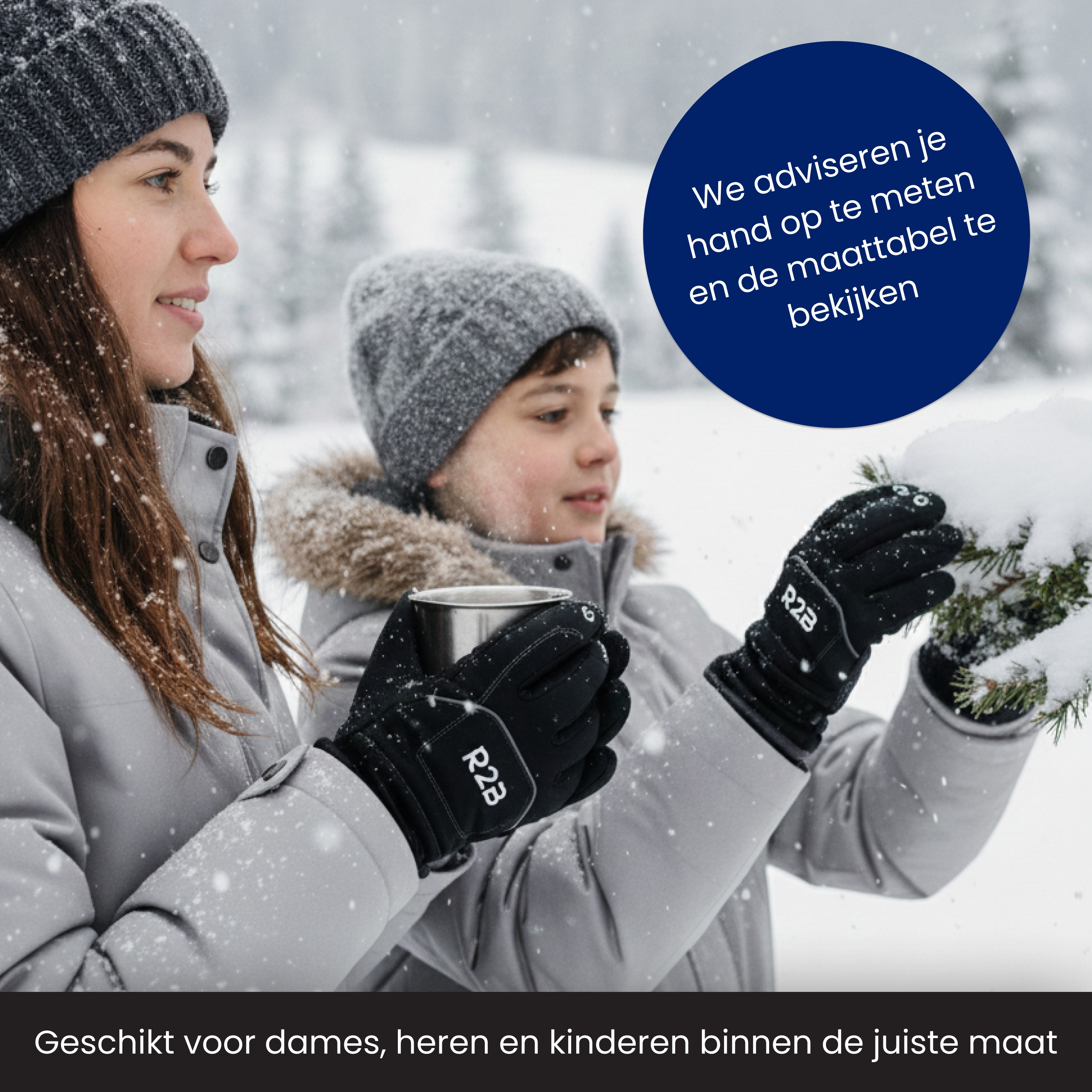 Two people in winter jackets and gloves, holding a mug and snow-covered branch. Snow is falling.