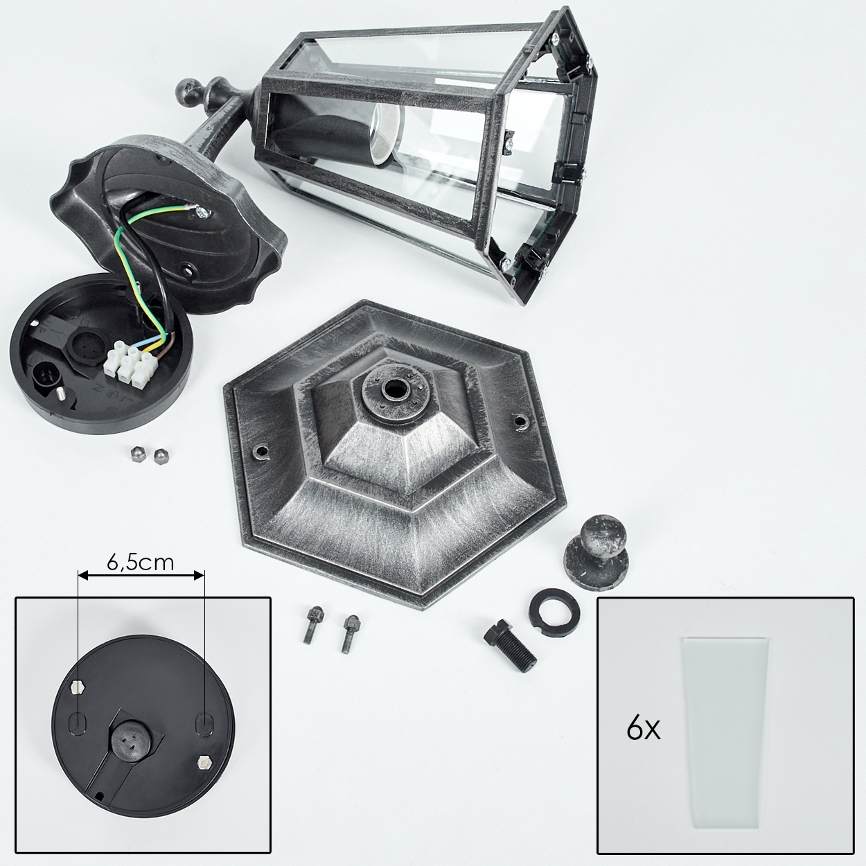 Zerlegte Teile einer Außenlampe auf weißem Hintergrund: Sockel, Glasscheiben, Verkabelung, Schrauben und Lampenkopf.