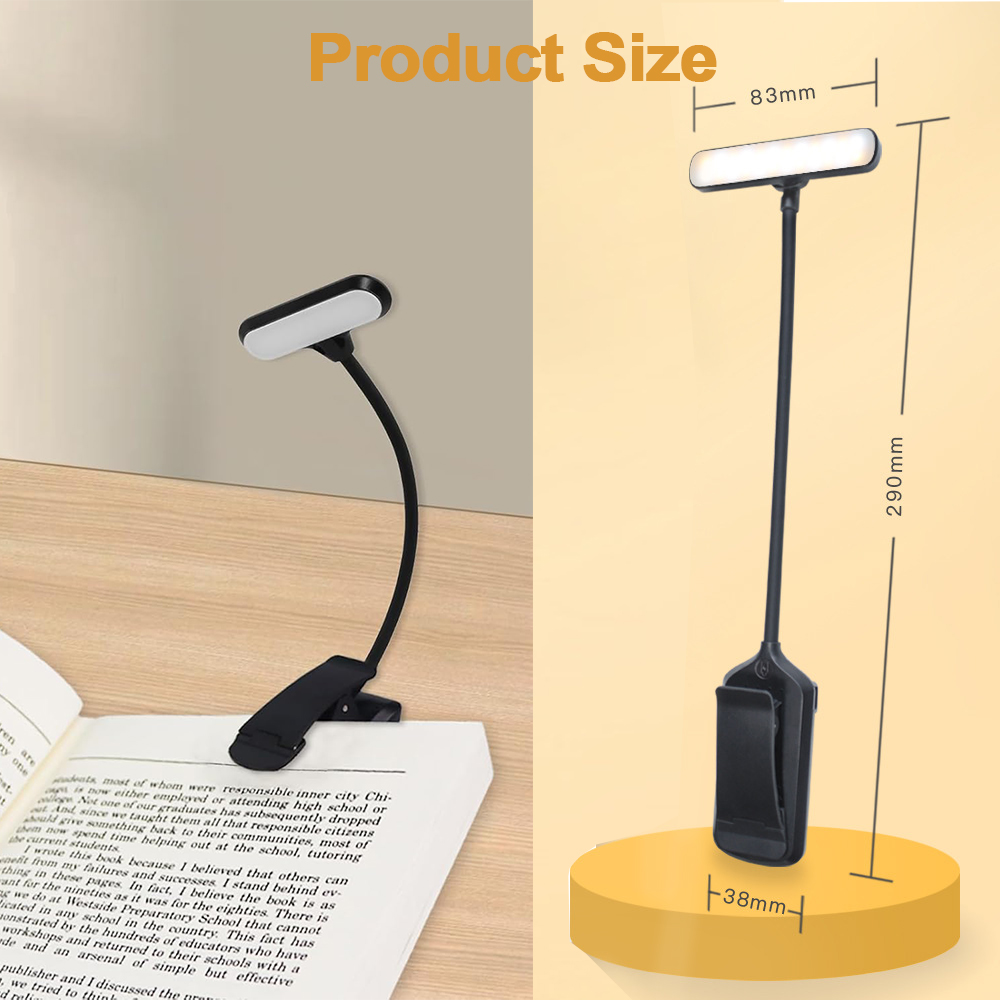 Una lampada da lettura nera è attaccata a un libro. La lampada ha la parte superiore bianca e si trova su una superficie gialla.